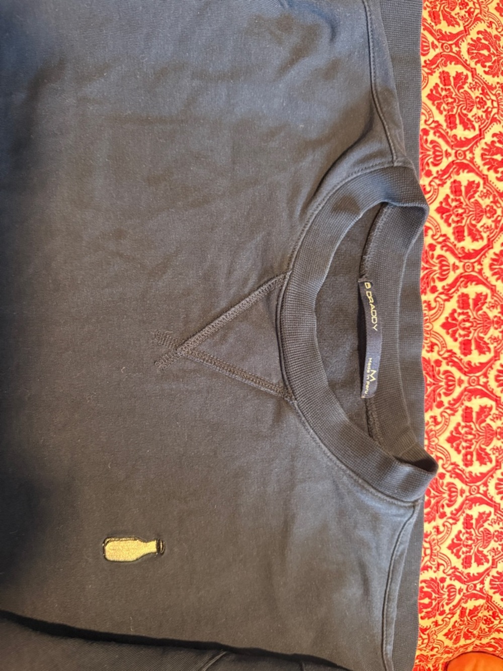 Navy B Draddy Crewneck Sweatshirt with Small Yellow Bottle Patch. Size Medium